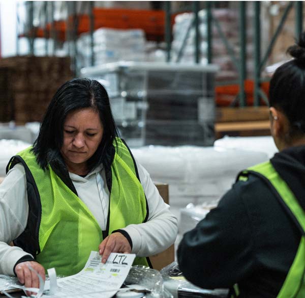 Trucking company employee handling imported goods in customs bonded warehouse